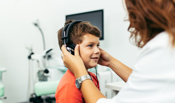 Photo of child performing a hearing test