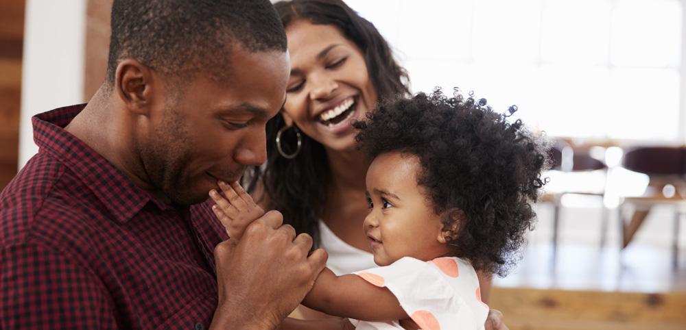 Couple Smiling with Young Child - Dad Kissing Child's Hand