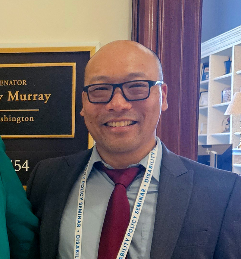 Photo: Ed Lam standing outside of Senator Patty Murray's office at the Disability Policy Seminar in Washington DC - 2024.